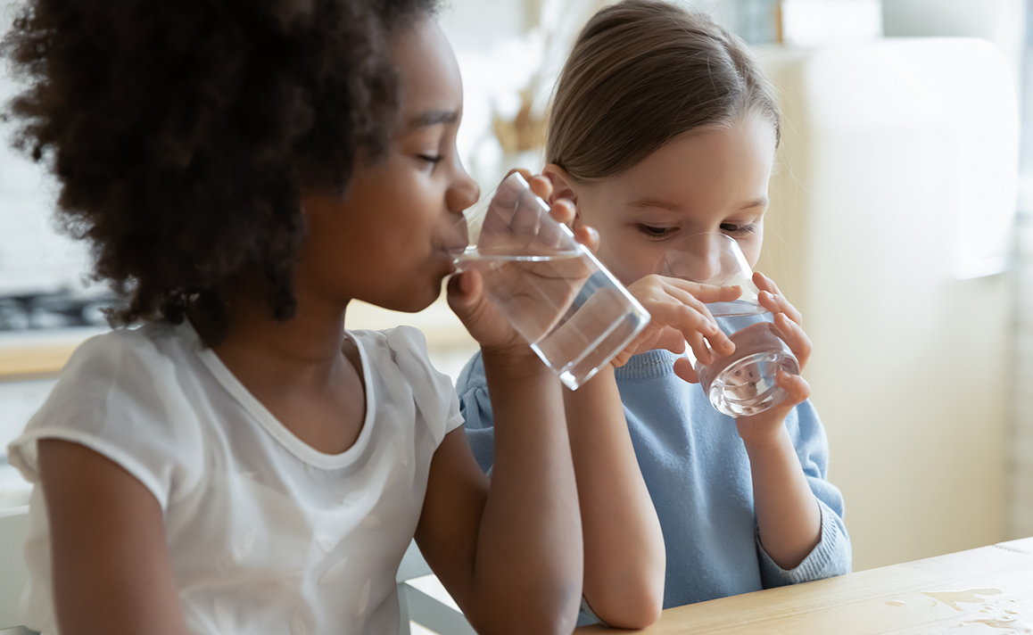 children drinking clean healthy water in child care facility